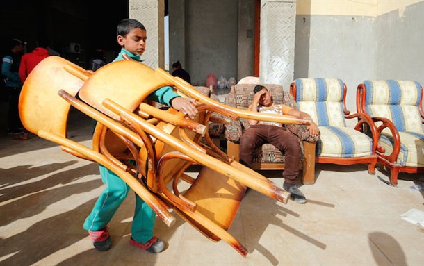 [Christian families carry belongings to the Saint Church in Ismailia after fleeing the escalating campaign by Islamic State militants in Al-Arish city. Photo from Aswat Masriya.]