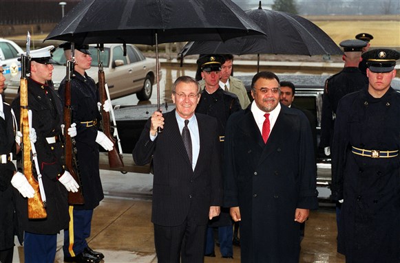 [Former Secretary of Defense Donald H. Rumsfeld (left) escorts Prince Bandar Bin Sultan Bin Abdul Aziz (right) through an honor cordon and into the Pentagon for a meeting on Feb. 5, 2001. Image from Wikimedia.]