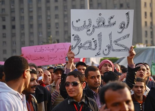 [A protester in Tahrir Square on 9 February 2011 holding a sign that reads \