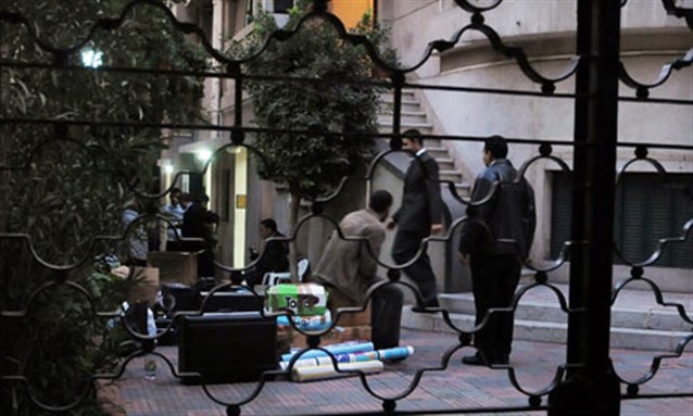 [Egyptian police raid a non-governmental organisation office in Cairo. Image from Associated Press]