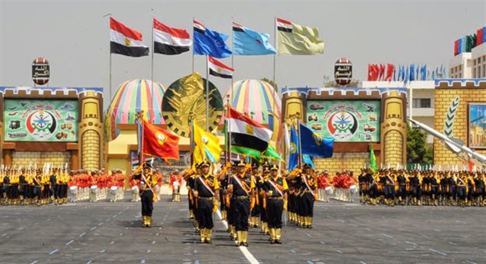 [Soldiers carrying each of the flags corresponding with their branch of the armed forces. Photo credit is to: Hipster Ntvqi via Wikimedia Commons]