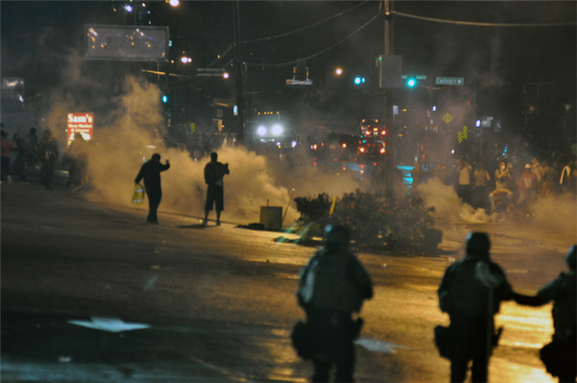 [Police in Ferguson, Missouri use tear gas against civilians. Image by Wikimedia Commons User \"Loavesofbread.\"]