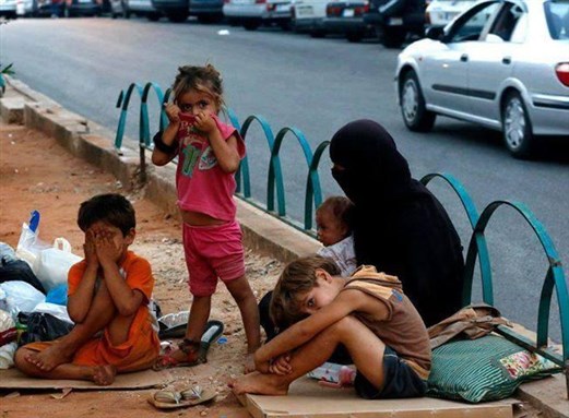 [A family from Homs in the streets of Beirut. From Khaled Erksoussi.]