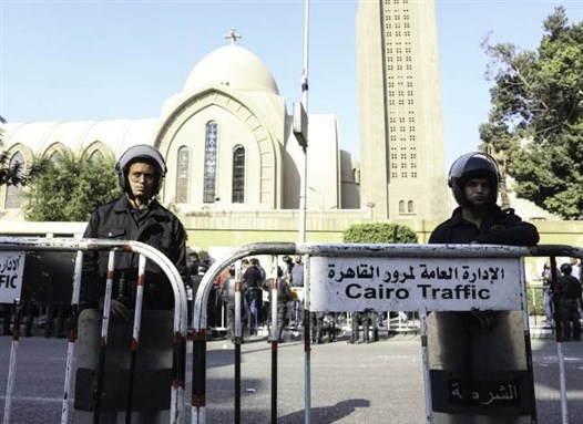 [Hundreds gather outside Coptic Orthodox Cathedral after the church explosion. Photo from Aswat Masriya.]