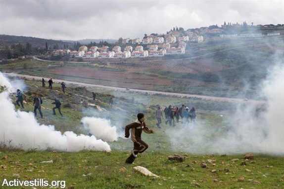 [Halamish on the hillside across Road 465 in the background. Photo: Anne Paq/ ActiveStills.org