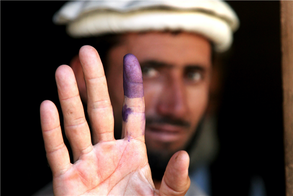An Afghan elder shows his inked finger to show he voted during the heavily anticipated Afghanistan elections in Barge Matal, Afghanistan, Aug. 20, 2009. Photo via Wikimedia Commons.