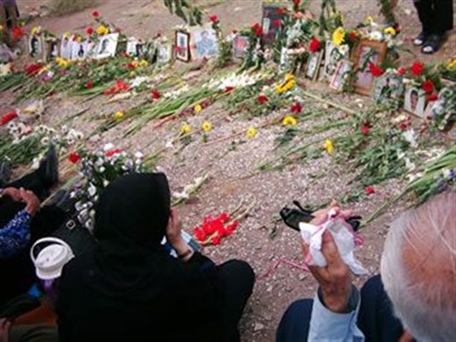 [Families visiting unmarked graves in Khavaran]
