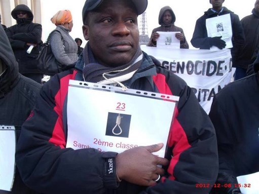 [Mauritanians rally to demand justice for `state-sponsored genocide` in front of France`s Mauritanian embassy on 8 December. Photo from @SaidouWane.]