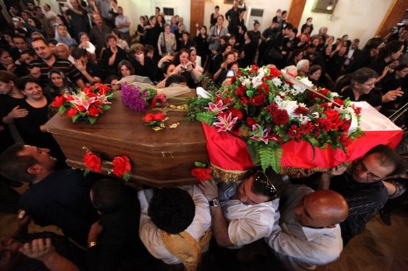 [Residents carry a coffin at the funeral for Our Lady of Salvation victims. Image from unknown source]