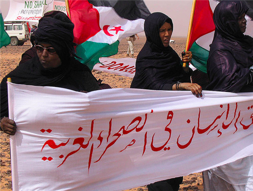[Sahrawi women protest against the Moroccan-built wall that divides the Western Sahara. Image from Flickr/Saharauiak.]
