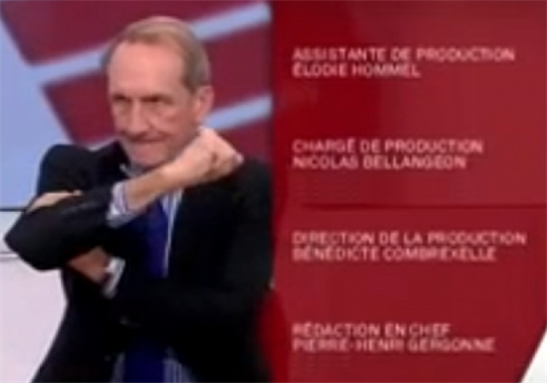 [Gérard Longuet gestures an \"up yours\" to Algerian Minister of War Veterans, Cherrif Abbas. Screenshot taken from Public Senat.]
