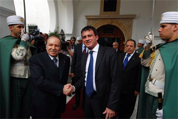 [Algerian President Abdelaziz Bouteflika, left, greets French Interior Minister Manuel Valls before a meeting in Algiers, Sunday, 14 October 2012. Photo by Sidali Djarboub via AP.]