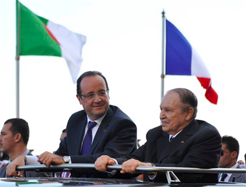 [French President Francois Hollande, left, and Algerian President Abdelaziz Bouteflika stand in a car as they drive through Algiers Wednesday, 19 December 2012. Image by Anis Belghoul/AP Photo.]
