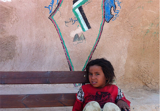 [Crop of image of Jahalin Bedouin girl in front of a school. Image by dombook11.]