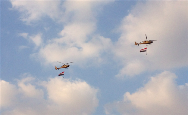 [Military helicopters fly Egyptian flags over Tahrir Square protests. Image by Maha ElNabawi/Mada Masr.]