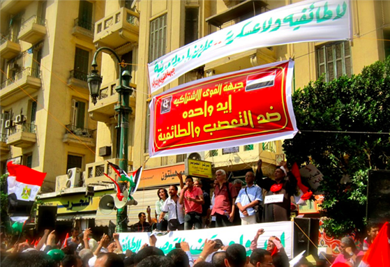 [Coalition of Socialist Forces carry a banner that reads: \"One hand against sectarianism and discrimination.\" Image by Gigi Ibrahim/Flickr.]