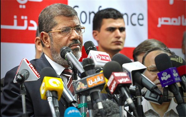 [President Morsi delivers a press conference. Image by Jonathan Rashad/Flickr.]
