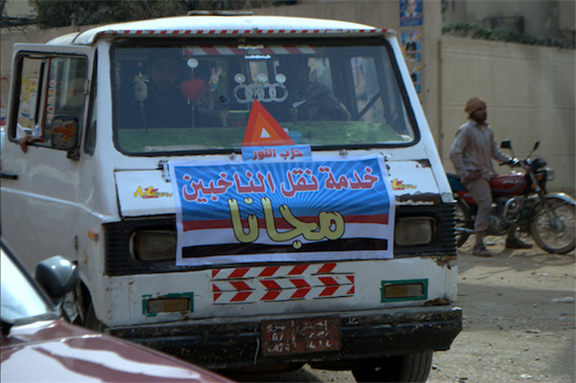[14 December 2011, microbus offers to transport people for free to the polling stations sponsortered by Nour Part. Image originally posted to Flickr by Lilian Wagdy]