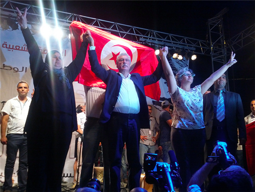 [Mbarka Brahmi, Hama Hamami and Basma Belaid join hands in opposition to the Tunisian government. Photo courtesy of Tunisia Live.]
