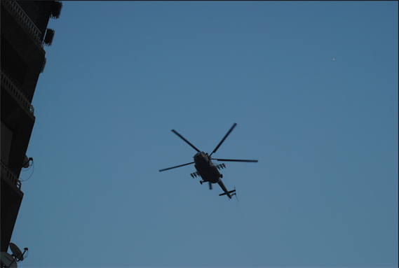 [28 June 2013, a military helicopter flies over ant-Morsi protesters near Tahrir square, Cairo, Egypt. Image originally posted to Flicker by Lilian Wagdy]