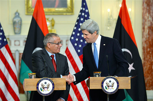 [Prime Minister Ali Zeidan shakes hands with US Secretary of State John Kerry. Photo courtesy of Wikimedia Commons.]