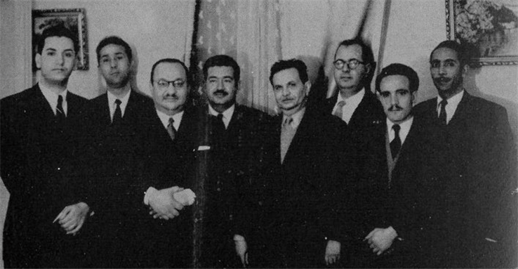 [Larbi Ben M`Hidi, Mohamed Boudiaf, Hocine Aït-Ahmed, Ahmed Ben Bella, Fathi Dib after a meeting on weapons transfer. Image from Wikimedia Commons.]