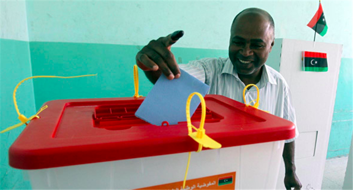 [A Libyan citizen casts his vote in Libya’s most recent elections. Photo courtesy of the High National Election Commission.]
