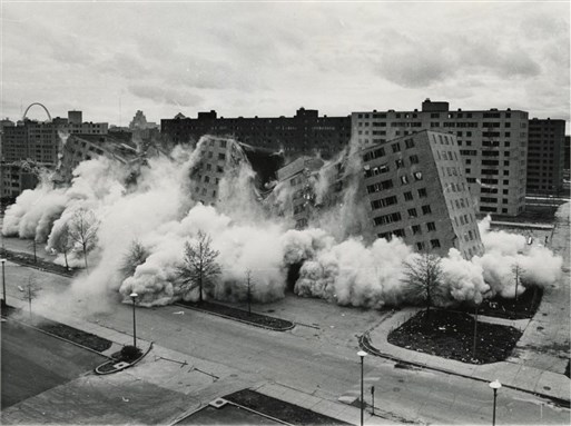 [Explosives bring down the Pruitt-Igoe public housing towers in St. Louis in 1972. Some former residents got housing assistance to settle in Ferguson and other inner-ring suburbs. Image via Wikimedia Commons]