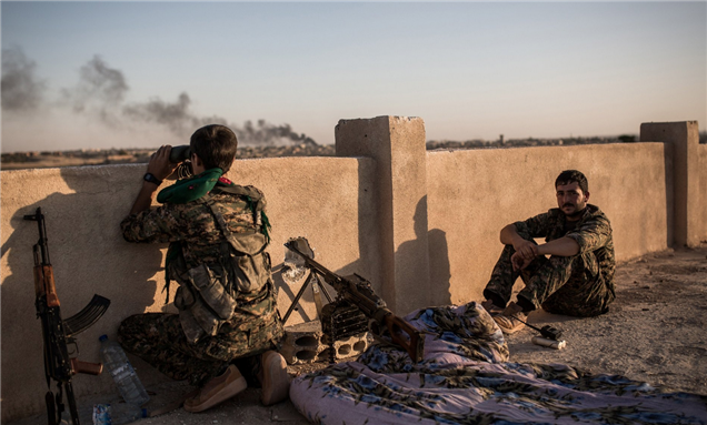[Image of Kurdish fighters during clashes with Islamic State militants near Hasakah, Syria. Image by Uygar Onder Simsek via Getty Images]