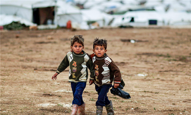 [Image of Syrian boys whose family fled their home in Idlib. Image by Freedom House via Flickr]