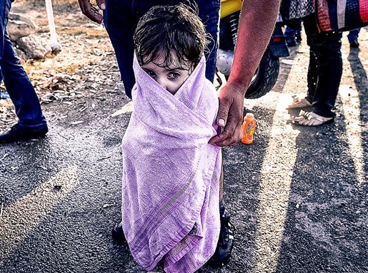 [Syrian child wrapped in a towel after arriving at Greek island of Kos, Image by Freedom House via flickr]
