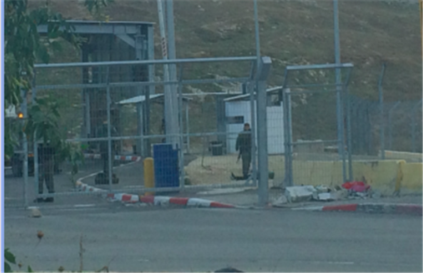 [The closed Container checkpoint with Sadeq Ziad Gharbiyeh’s body visible on the ground, on 10 November 2015. Image by author.]