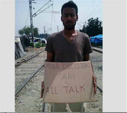  [An asylum seeker holds a sign addressing EU leaders at the Greek border with the former Yugoslav Republic of Macedonia. Image: MSF]