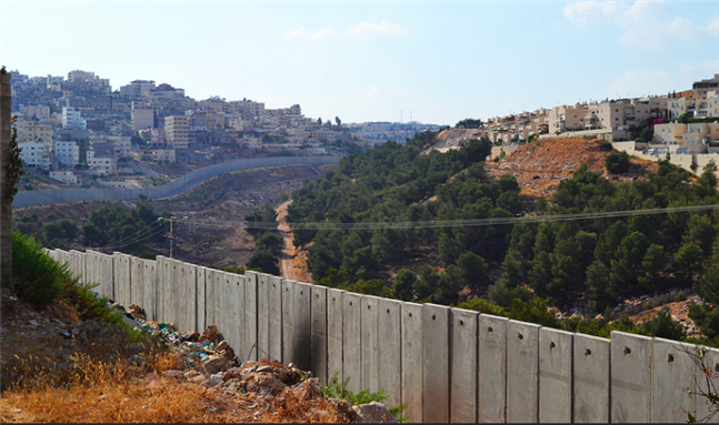 [Palestinian communities and Israeli settlements are divided by the separation barrier in east Jerusalem. Photo by Eoghan Rice and uploaded from Flickr]