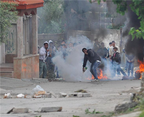 [During the morning hours approximately 100 Palestinians gathered near El-Arrub, southwest of Bethlehem, in a demonstration agains illegal theft of their land by Israeli settlers. The Israeli army responded as usual with massive tear-gas attack. May 2011. Israel Defense Forces via Flickr]