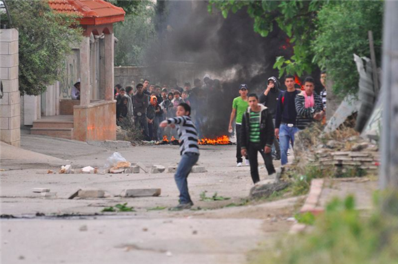 [May 15, 2011. During the morning hours approximately 100 Palestinians gathered near El-Arrub, southwest of Bethlehem, in a demonstration agains illegal theft of land by Israeli settlers. The Israeli army responded as usual with massive tear-gas attack. Photo by Israel Defense Forces and uploaded from Wikimedia Commons]