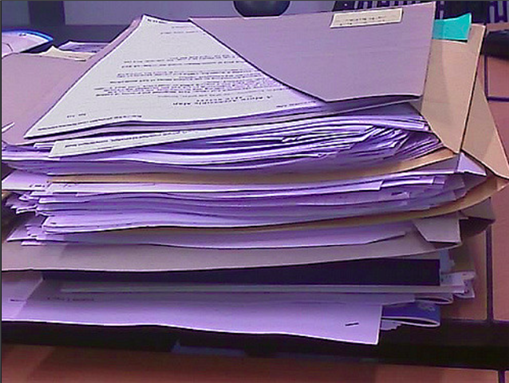 [Pile of papers. Taken by biblioteekje, uploaded via Flickr]