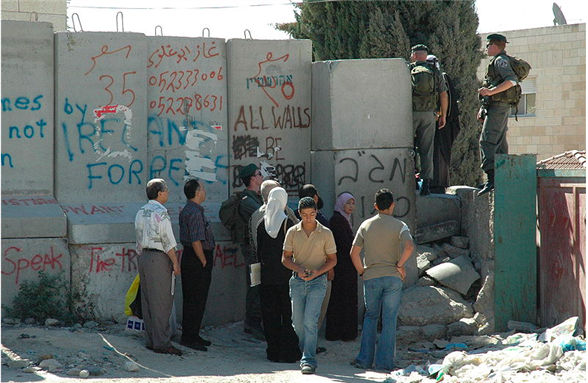 [A checkpoint in the Israeli Barrier in the West Bank, near Abu Dis. Photo taken by Justin McIntosh, uploaded via Wikimedia Commons]