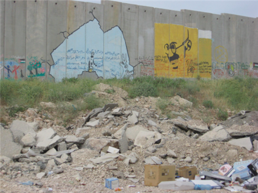 [Graffiti paintings on the wall by British graffiti artist Banksy. Image uploaded via Creative Commons]