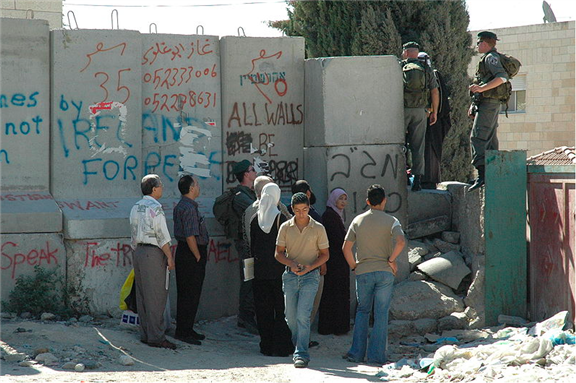 [A checkpoint in the Israeli Barrier in the West Bank, near Abu Dis. Picture taken by Justin McIntosh and uploaded via Wikimedia Commons]