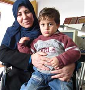 [Wafa al-Radea (thirty-nine) together with her son Iyad (three). Image from pchrgaza.org.]