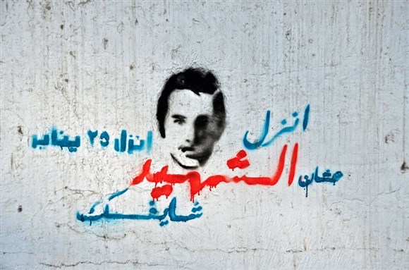 [Graffiti: \"Come out on January 25th because the martyr is watching you. Photo by Eric Knecht]\" 