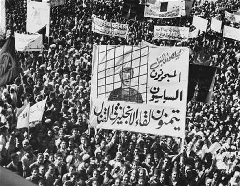 [A huge banner demanding release of political prisoners is carried by Egyptians in a procession through Cairo streets on 14 November 1951. Photo Source: AP]