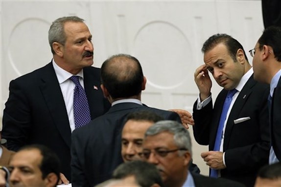 [Former Economy Minister Zafer Çaglayan, left, and European Affairs Minister Egemen Bagis, second right, during a parliamentary debate on corruption charges against four cabinet ministers of Prime Minister Erdogan, in Ankara, 5 May 2014. (AP Photo/Burhan Ozbilici)]