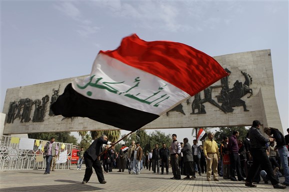 [An Iraqi waving the Iraqi Flag at Tahrir Square. Image from unknown archive]