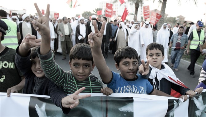 [Children take the frontline at an opposition rally, Budaiya Highway, Bahrain, 25 November, 2011. Image by Saeed Saif.]