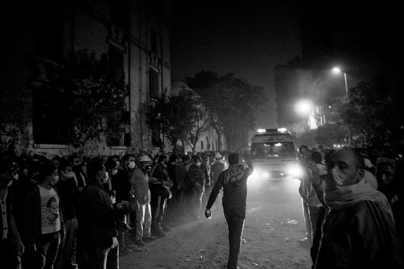 [Ambulance arriving in Mohamed Mahmoud Street during the November 2011 clashes. Photo by Hossam el-Hamalawy]