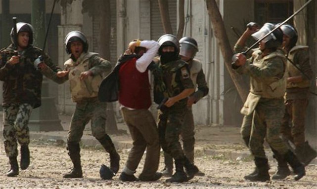 [Military soldiers attacking demonstrators at the Cabinet on Friday 16 December. Image from Reuters]