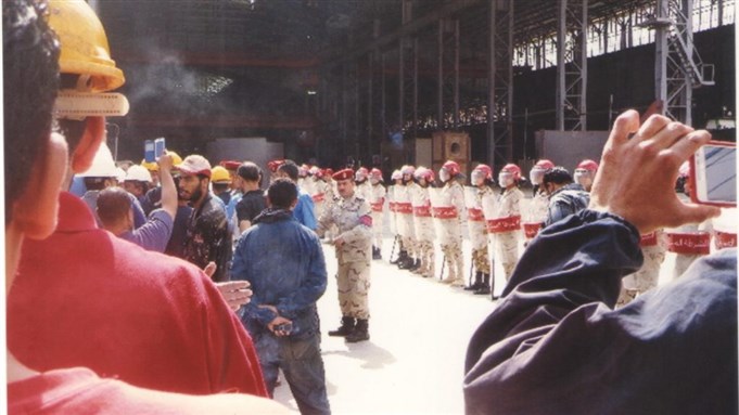 [Alexandria Shipyard workers. Photo from the Egyptian Center for Social and Economic Rights website.] 