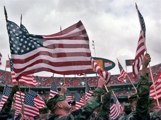 [US soldiers wave flags at a ceremony a few days after September 11, 2001. Photo by Jason Cook/AP]
